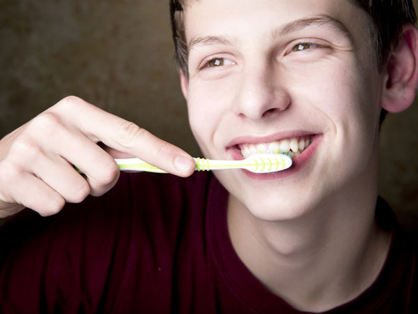can you brush your gums too hard